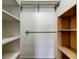 This closet has both white shelving and wooden shelving, with bars to hang clothing at 8200 Westfield Dr, Port Richey, FL 34668