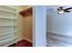 Walk-in closet with built-in shelving adjacent to bedroom and bathroom at 8200 Westfield Dr, Port Richey, FL 34668