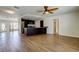 Open-concept layout with wood-look tile floors, seamlessly connects the living area to the kitchen at 8200 Westfield Dr, Port Richey, FL 34668