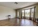 Inviting living area featuring wood-look tile flooring, large windows, and neutral wall color at 8200 Westfield Dr, Port Richey, FL 34668