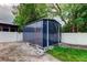 Durable storage shed providing ample space, set in a well-maintained backyard with grass at 8200 Westfield Dr, Port Richey, FL 34668