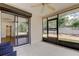 Enclosed back porch featuring durable tile flooring, backyard access, and serene views at 8200 Westfield Dr, Port Richey, FL 34668
