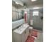 Clean bathroom with a granite countertop, a shower stall, and white cabinetry at 8616 Pinafore Dr, New Port Richey, FL 34653