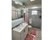 Bathroom featuring a modern vanity, mirror, and a glass-enclosed shower with tiled walls at 8616 Pinafore Dr, New Port Richey, FL 34653