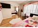 Well-lit bedroom with wood floors, and a sliding closet door at 8616 Pinafore Dr, New Port Richey, FL 34653