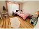Comfortable bedroom with bright natural light and hardwood floors at 8616 Pinafore Dr, New Port Richey, FL 34653