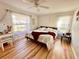 Serene bedroom featuring hardwood floors and natural light, creating a peaceful retreat at 8616 Pinafore Dr, New Port Richey, FL 34653