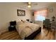 Cozy bedroom with a ceiling fan, a window, and a dark accent wall at 8616 Pinafore Dr, New Port Richey, FL 34653