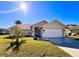 Charming single-story home featuring a well-manicured lawn and an attached two-car garage at 8616 Pinafore Dr, New Port Richey, FL 34653