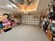 Spacious garage with gray floors and a garage door, providing ample parking and storage space at 8616 Pinafore Dr, New Port Richey, FL 34653