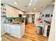 Well-lit kitchen featuring stainless steel appliances and a spacious granite-topped island at 8616 Pinafore Dr, New Port Richey, FL 34653