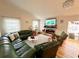 Inviting living room with vaulted ceilings, fireplace, and hardwood floors for comfortable living at 8616 Pinafore Dr, New Port Richey, FL 34653
