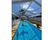 Enclosed pool with an inflatable toy, ideal for cooling off and having fun during the hot summer months at 8616 Pinafore Dr, New Port Richey, FL 34653