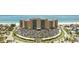Stunning aerial view of beachfront condo building with manicured grounds and ample parking at 880 Mandalay Ave # C512, Clearwater Beach, FL 33767
