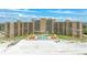 Resort-style beachfront condo showcasing pool, beach access, and well-manicured landscaping at 880 Mandalay Ave # C512, Clearwater Beach, FL 33767