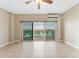 Inviting living room with tile floor, ceiling fan and sliding glass doors to balcony with a scenic view at 880 Mandalay Ave # C512, Clearwater Beach, FL 33767