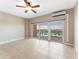 Bright living space with tile flooring, ceiling fan, and sliding glass doors to a private balcony at 880 Mandalay Ave # C512, Clearwater Beach, FL 33767