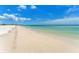 Picturesque view of a white sandy beach meeting turquoise water, inviting for relaxation and beachcombing at 880 Mandalay Ave # C512, Clearwater Beach, FL 33767