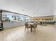 Common room with dining tables, tiled flooring, and floor-to-ceiling windows with tropical views at 880 Mandalay Ave # C512, Clearwater Beach, FL 33767
