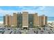 A high-rise condo building with a parking lot in the foreground, near the beach, offering convenient amenities at 880 Mandalay Ave # C512, Clearwater Beach, FL 33767