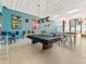 Bright game room with billiard table, ping pong setup, bar seating, and ocean views at 880 Mandalay Ave # C512, Clearwater Beach, FL 33767