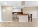 Well-lit kitchen with white appliances, breakfast bar, and tile backsplash at 880 Mandalay Ave # C512, Clearwater Beach, FL 33767