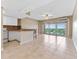 Bright living room and kitchen with tile floors, ceiling fan, and sliding glass doors to balcony at 880 Mandalay Ave # C512, Clearwater Beach, FL 33767
