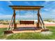 A charming wooden swing set overlooking a beautiful beach, offering a relaxing spot to enjoy the view at 880 Mandalay Ave # C512, Clearwater Beach, FL 33767