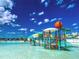 Fun water park featuring slides, colorful play structures, and clear, shallow water at 10702 Laxer Cay Loop, San Antonio, FL 33576