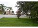 Backyard view with grass, fencing and trees at 11227 Thicket Ct, Tampa, FL 33624