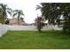 Residential backyard with grass, fencing and shade trees at 11227 Thicket Ct, Tampa, FL 33624