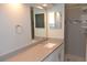 Bright bathroom features a large mirror, extended vanity, and tiled walk-in shower at 11227 Thicket Ct, Tampa, FL 33624