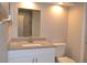 Bathroom showcasing vanity, toilet and mirror with a view of the tiled shower at 11227 Thicket Ct, Tampa, FL 33624