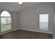 Bright bedroom with wood-look floors and windows offering ample natural light and a pleasant view at 11227 Thicket Ct, Tampa, FL 33624