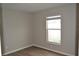 Neutral bedroom offers durable floors, fresh paint and a sun-filled window at 11227 Thicket Ct, Tampa, FL 33624