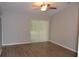 Spacious bedroom with wood-look floors, neutral walls, and a sliding glass door with private backyard access at 11227 Thicket Ct, Tampa, FL 33624