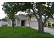 Charming single-story home with a well-manicured lawn and mature trees in a quiet neighborhood at 11227 Thicket Ct, Tampa, FL 33624