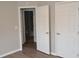 Hallway leading to bathroom and closet with hardwood floors and neutral paint at 11227 Thicket Ct, Tampa, FL 33624