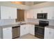 Updated kitchen featuring stainless steel appliances, white cabinets, and tile backsplash for a modern look at 11227 Thicket Ct, Tampa, FL 33624