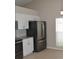Modern kitchen with stainless steel appliances, white cabinets, and a sleek backsplash for a clean aesthetic at 11227 Thicket Ct, Tampa, FL 33624