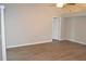 Bright living room with wood floors, neutral walls, ceiling fan, and white trim at 11227 Thicket Ct, Tampa, FL 33624