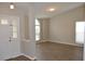 Open-concept living room featuring wood-look floors, neutral paint, and an abundance of natural light at 11227 Thicket Ct, Tampa, FL 33624