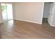 View of the living room with sliding glass doors leading outside and doorway to other rooms at 11227 Thicket Ct, Tampa, FL 33624
