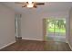 Open living room featuring wood flooring, neutral walls, and glass doors to the lanai at 11227 Thicket Ct, Tampa, FL 33624
