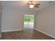 Bright living room featuring wood floors, a ceiling fan, and sliding glass doors to the screened-in porch at 11227 Thicket Ct, Tampa, FL 33624