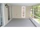 View of an enclosed back patio with sliding glass doors at 11227 Thicket Ct, Tampa, FL 33624