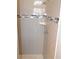 Shower featuring a tile surround with decorative accent band, and updated fixtures at 11227 Thicket Ct, Tampa, FL 33624
