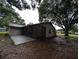 Exterior view of the home featuring a large lanai and mature trees providing shade at 11308 Echo View Dr, Odessa, FL 33556