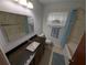 Light and airy bathroom with a large mirror, vanity, and a shower-tub combo at 11308 Echo View Dr, Odessa, FL 33556