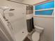Bathroom featuring updated tile shower with rainfall shower head and a new toilet at 11308 Echo View Dr, Odessa, FL 33556